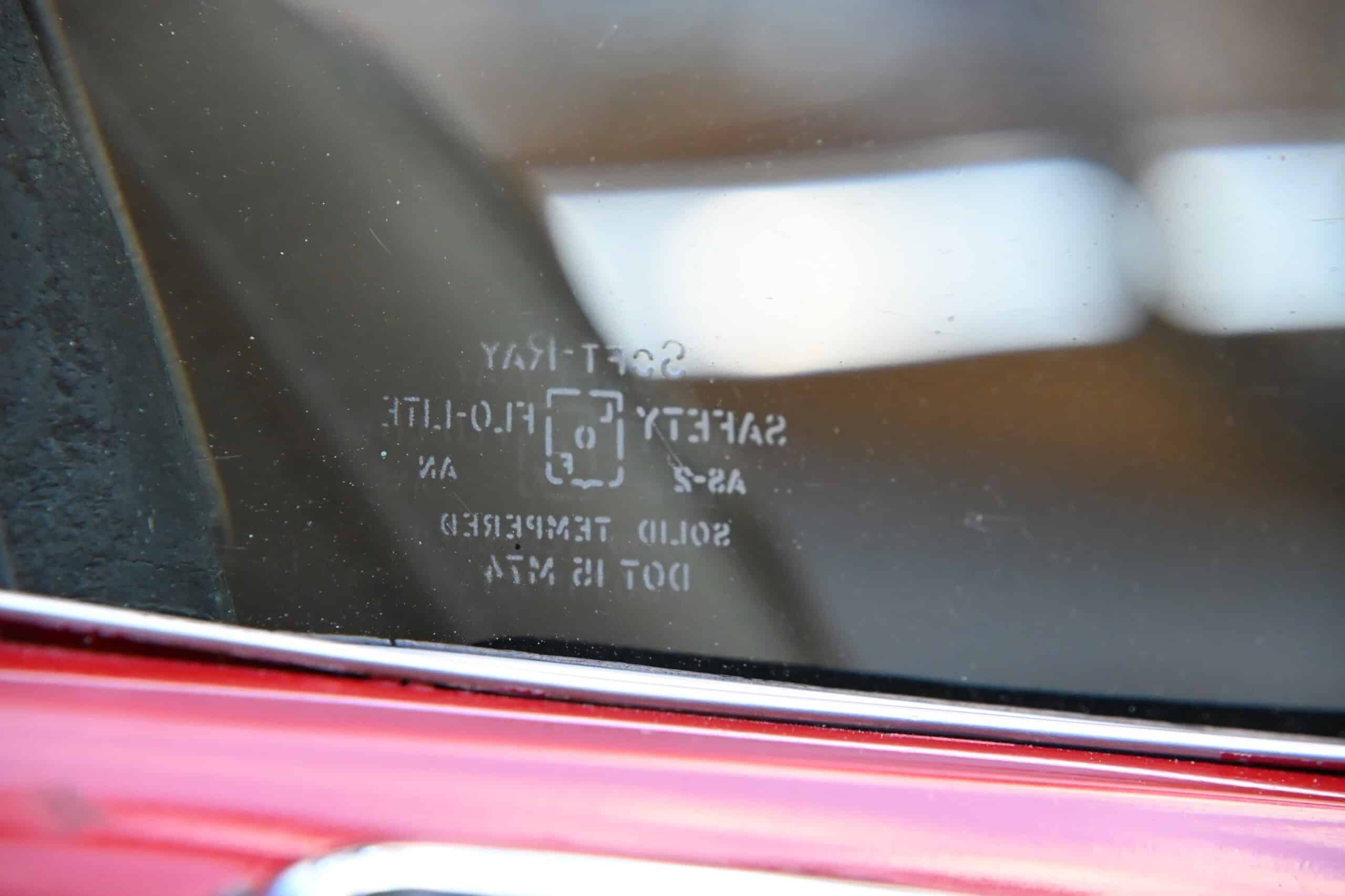 1972 Chevrolet corvette — Close-up of classic car windshield with safety and certification sticker.