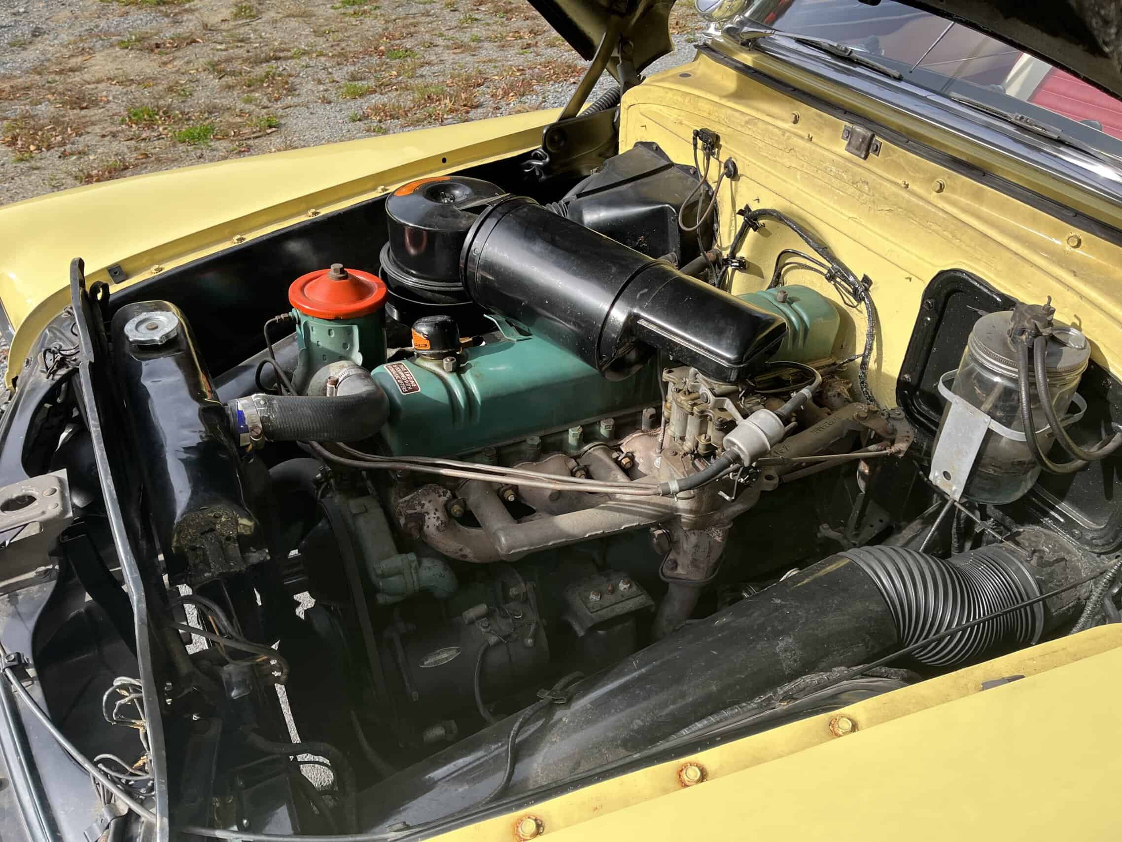 1953 Buick special — Close-up of classic car engine with black air filter and green engine block.