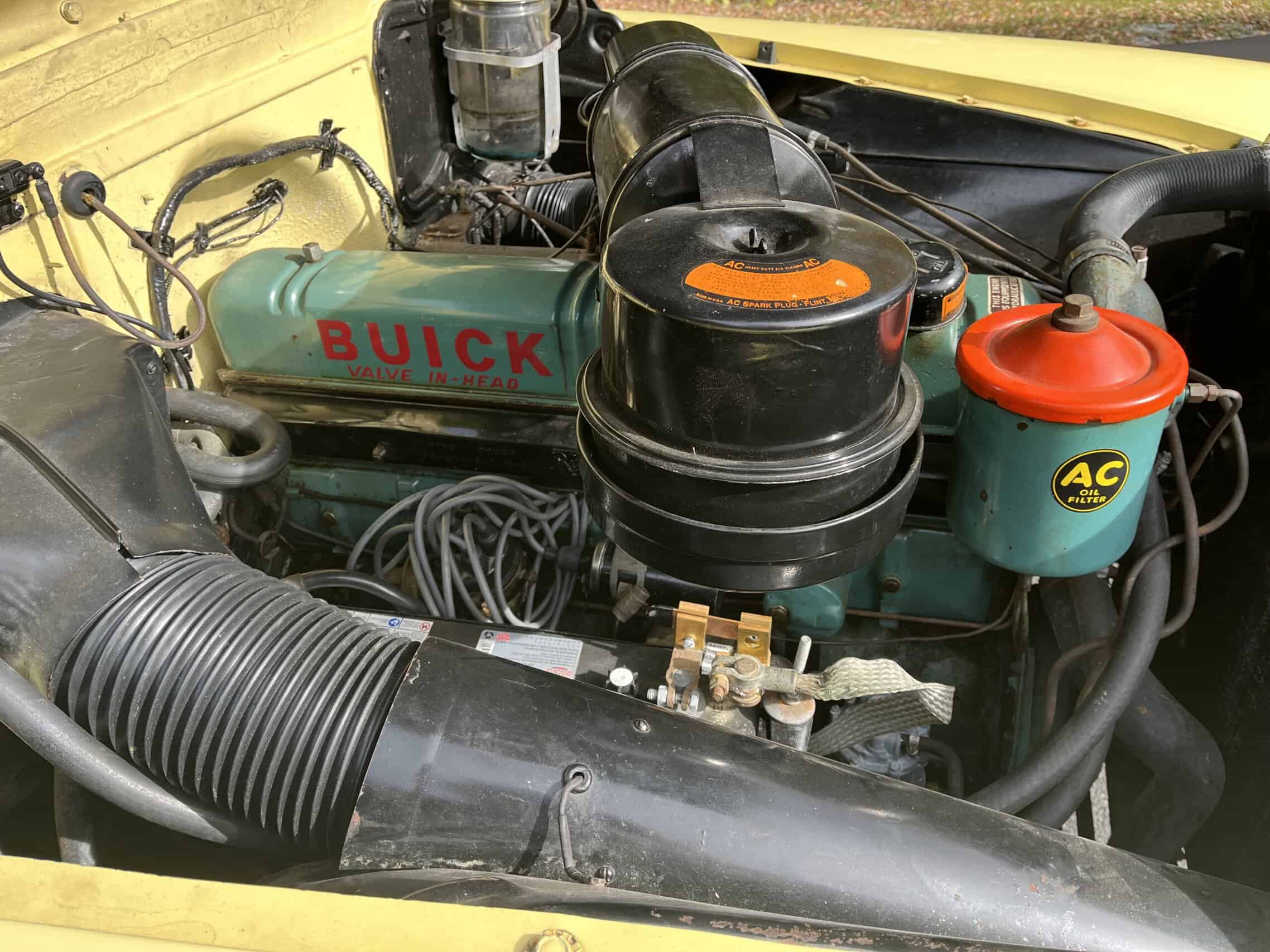 1953 Buick special — Close-up of classic car engine showing vintage parts and labels.