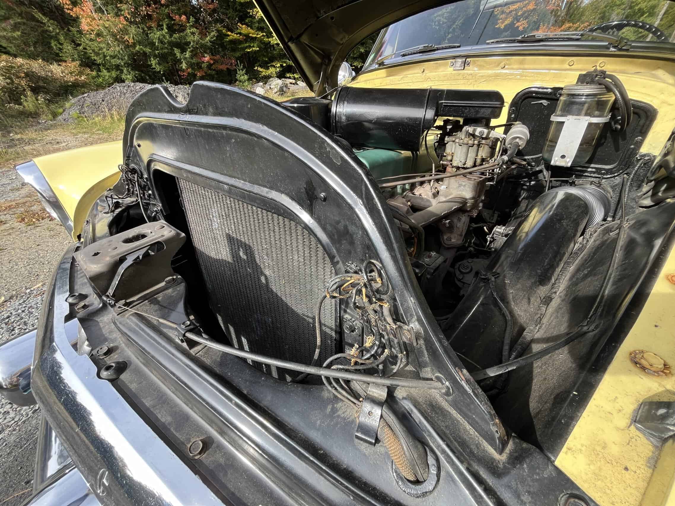 1953 Buick special — View of engine bay of classic car with open hood and visible engine parts.