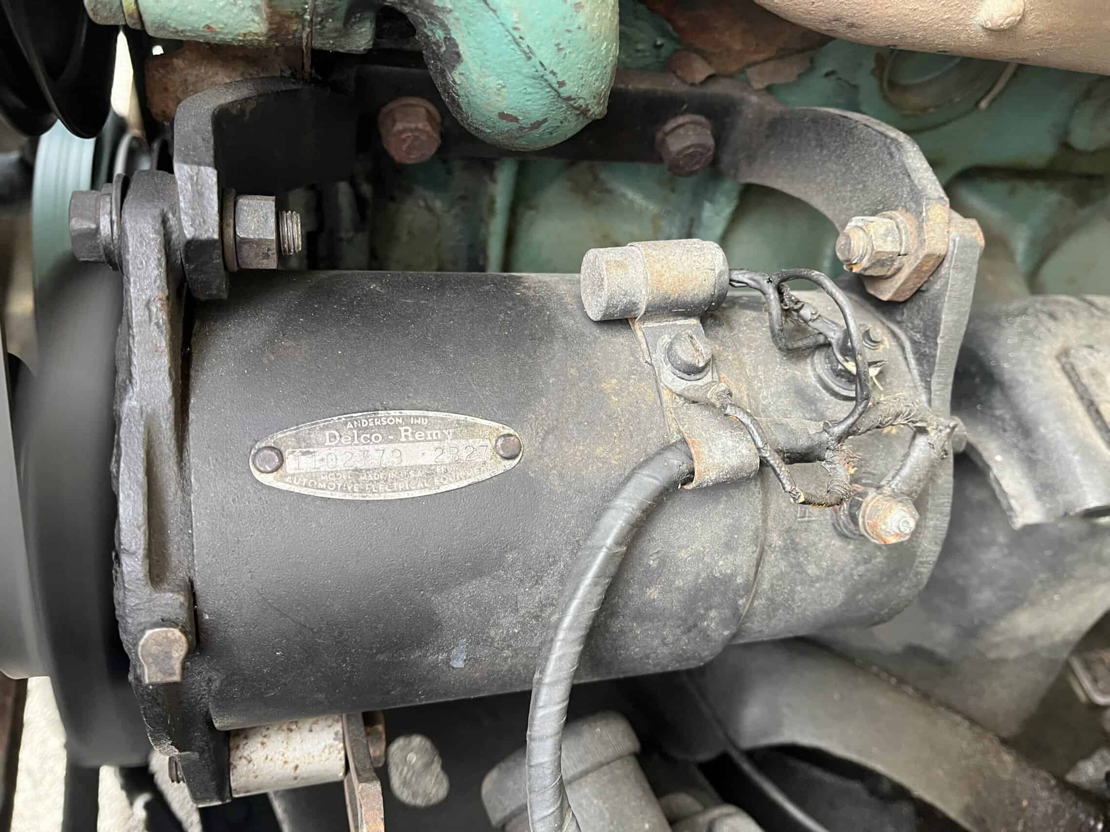 1953 Buick special — Close-up of a vintage car engine with visible components.