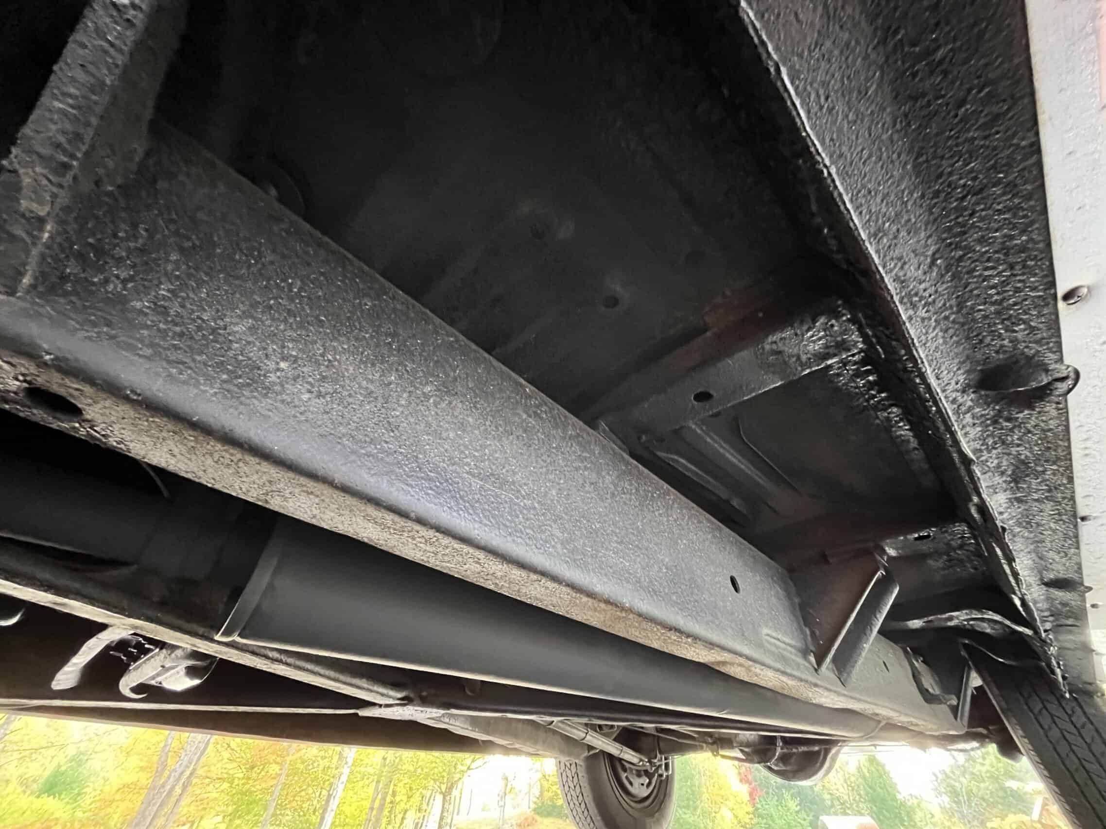 1953 Buick special — Underneath view of a classic car showing chassis and exhaust system.