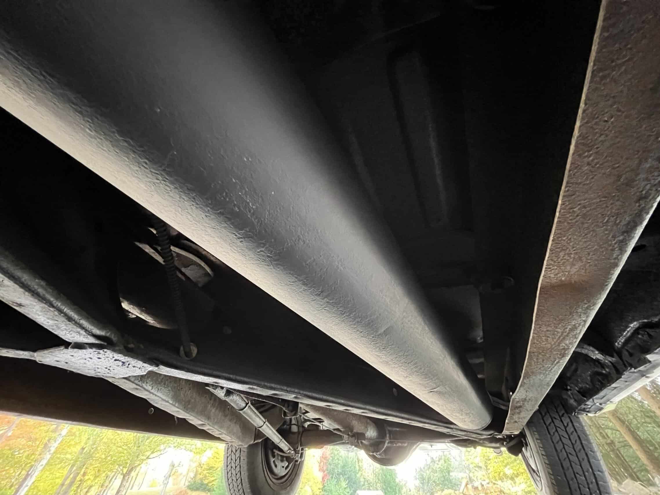 1953 Buick special — Underneath view of a classic car showing exhaust and suspension.