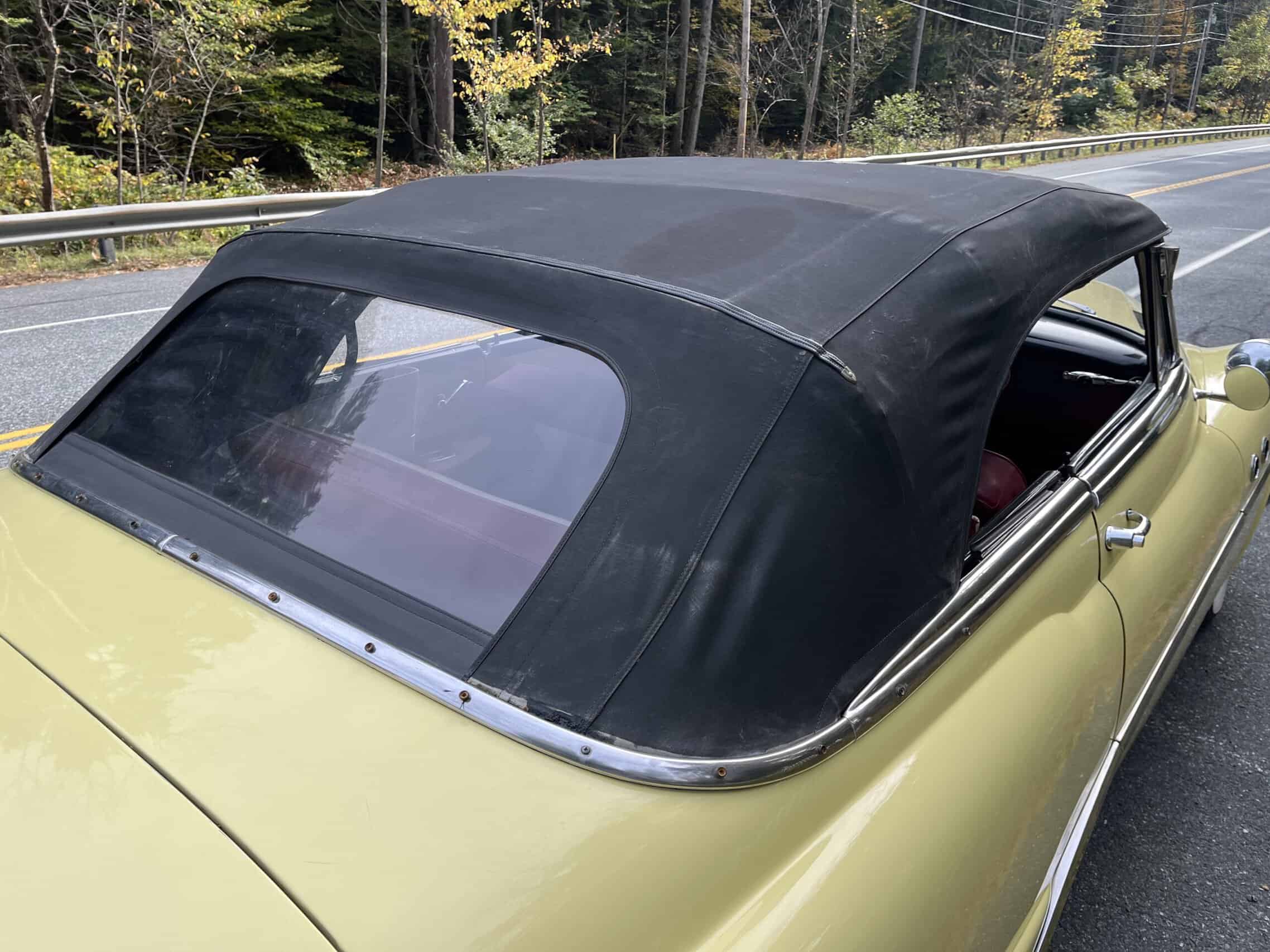 1953 Buick special — Exterior shot of a classic car with black convertible top on the road.