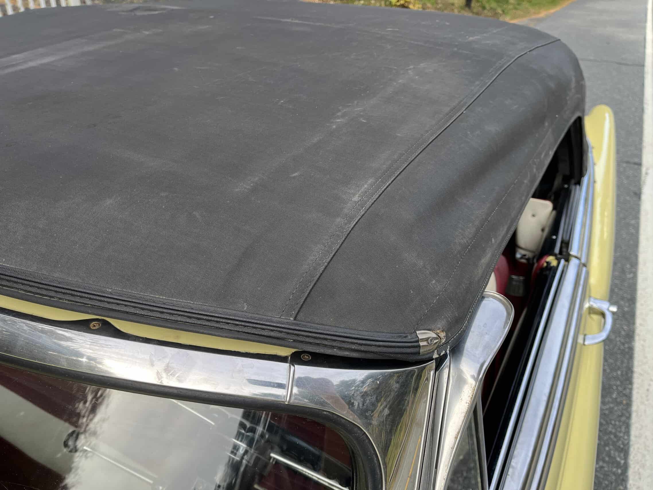 1953 Buick special — Close-up of classic car convertible roof and windshield.