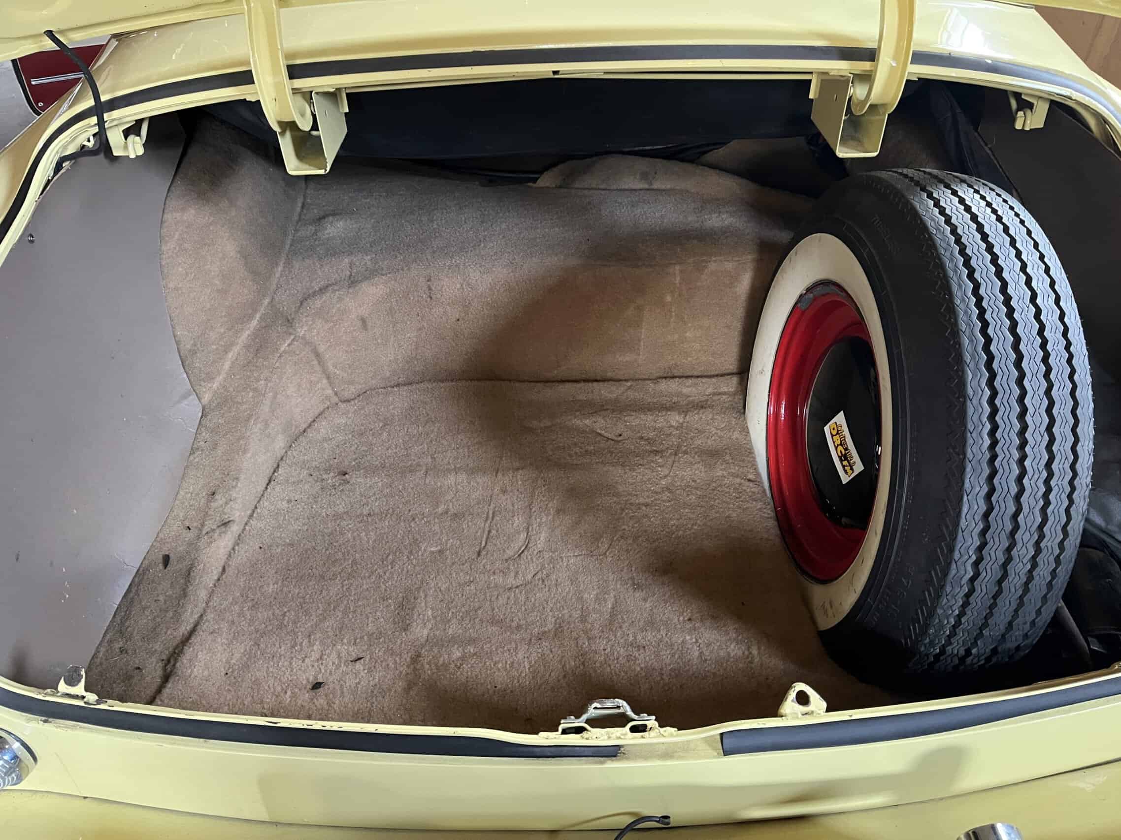 1953 Buick special — Open trunk of classic car showing interior and spare tire.