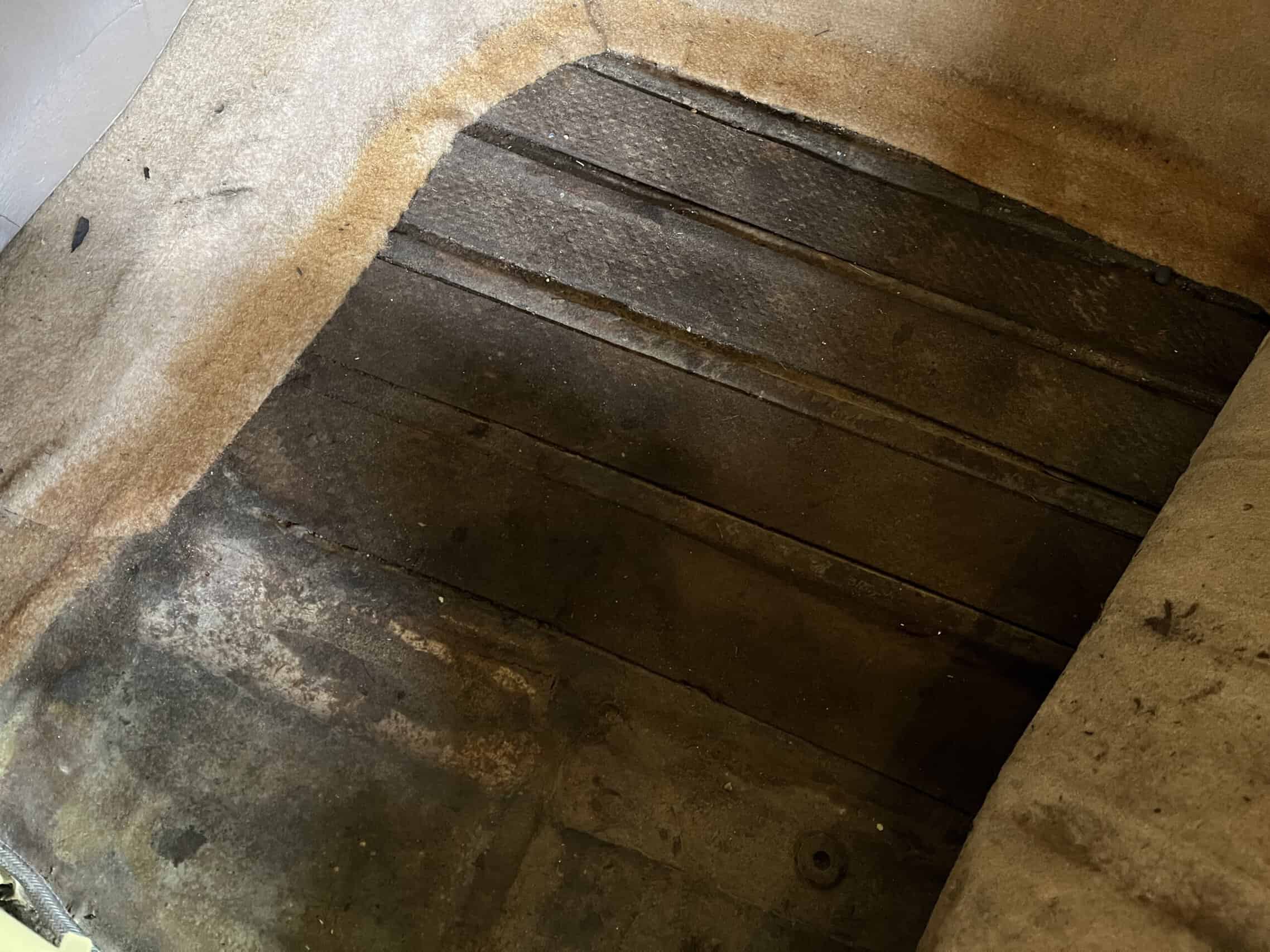 1953 Buick special — Close-up of worn wooden floor mat in classic car interior.