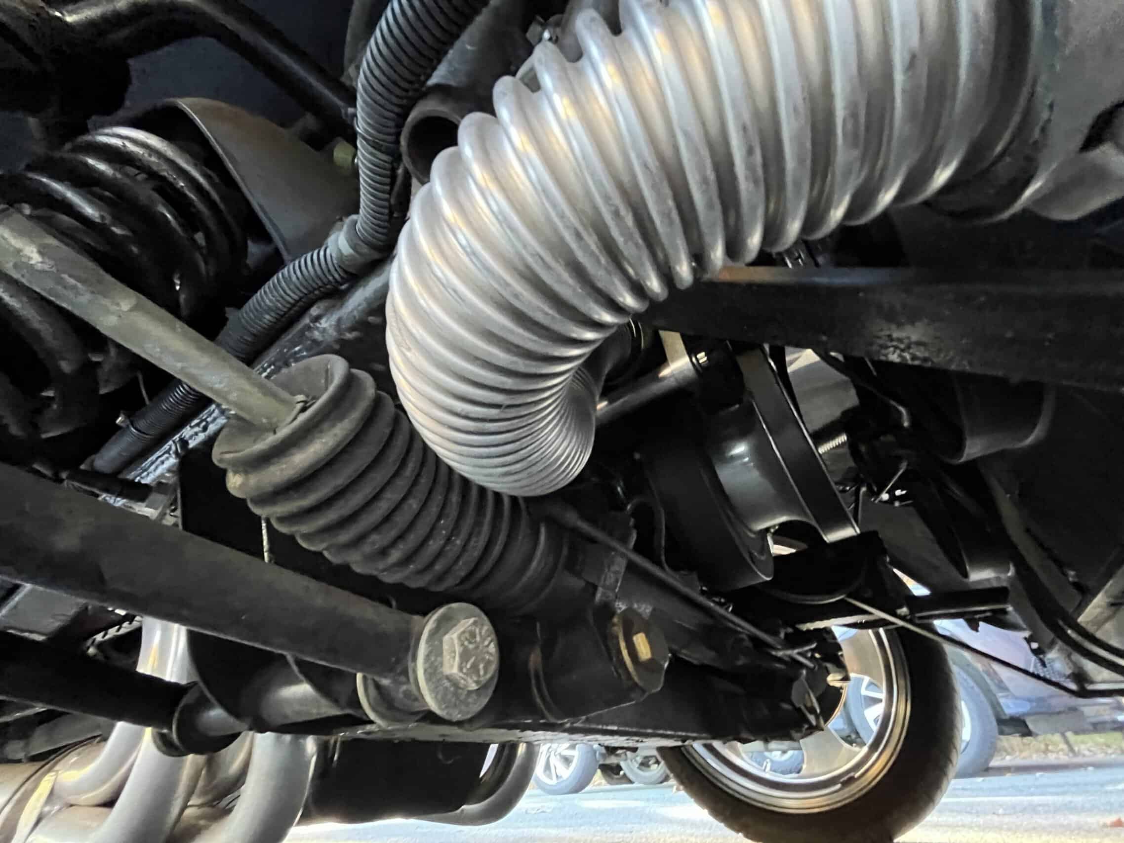 1941 Willys Custom Street Rod — Close-up of engine components and hoses in a classic car.