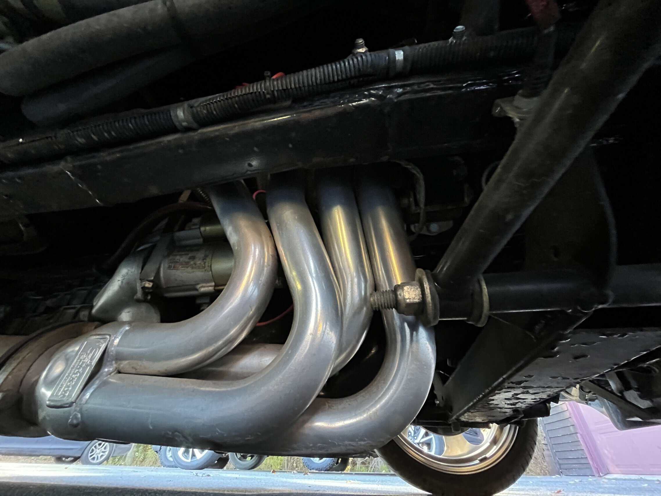 1941 Willys Custom Street Rod — Close-up of engine exhaust pipes in a classic car.
