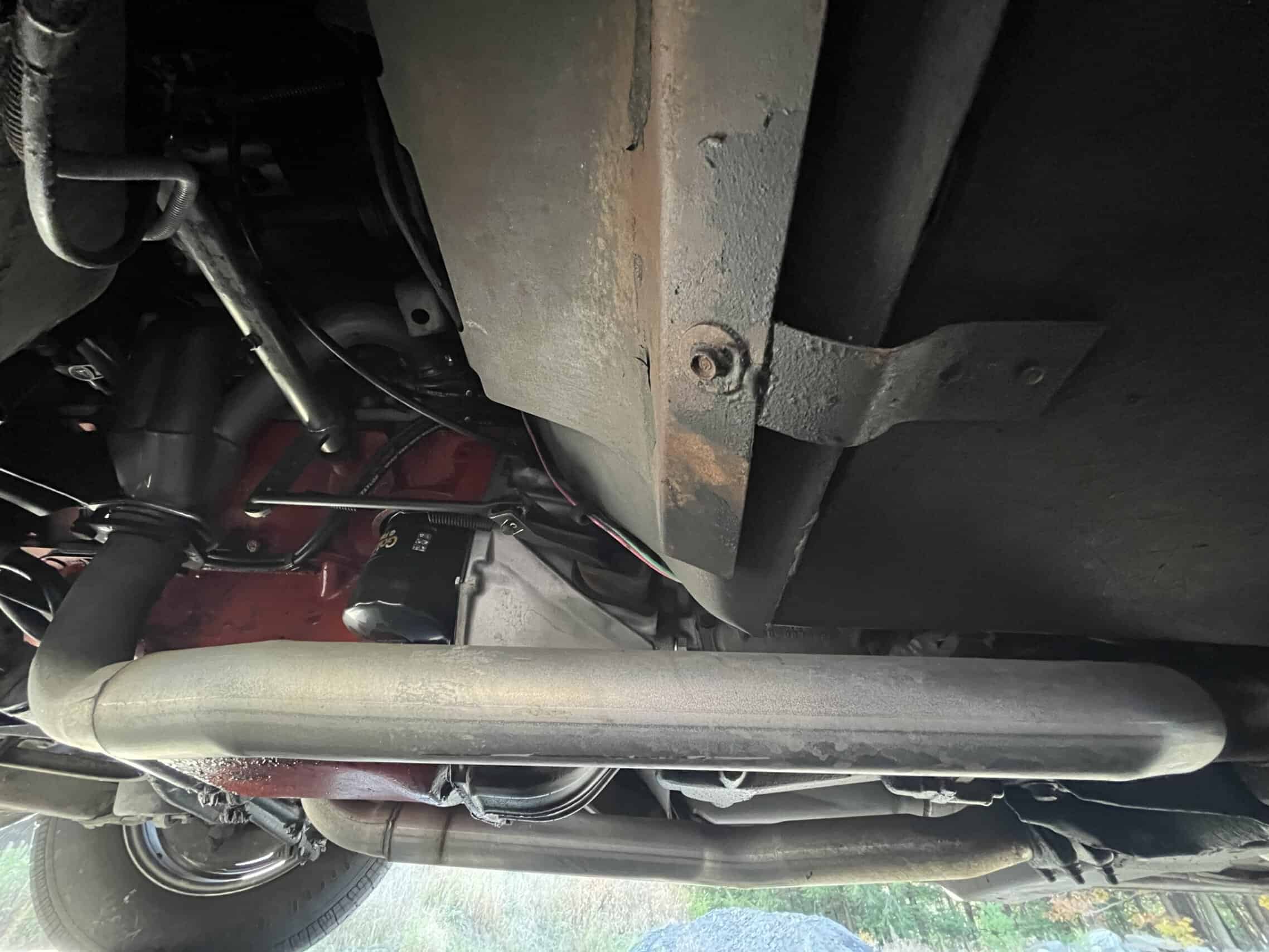 1972 Chevrolet corvette — Underneath view of a classic car showing engine and chassis components.