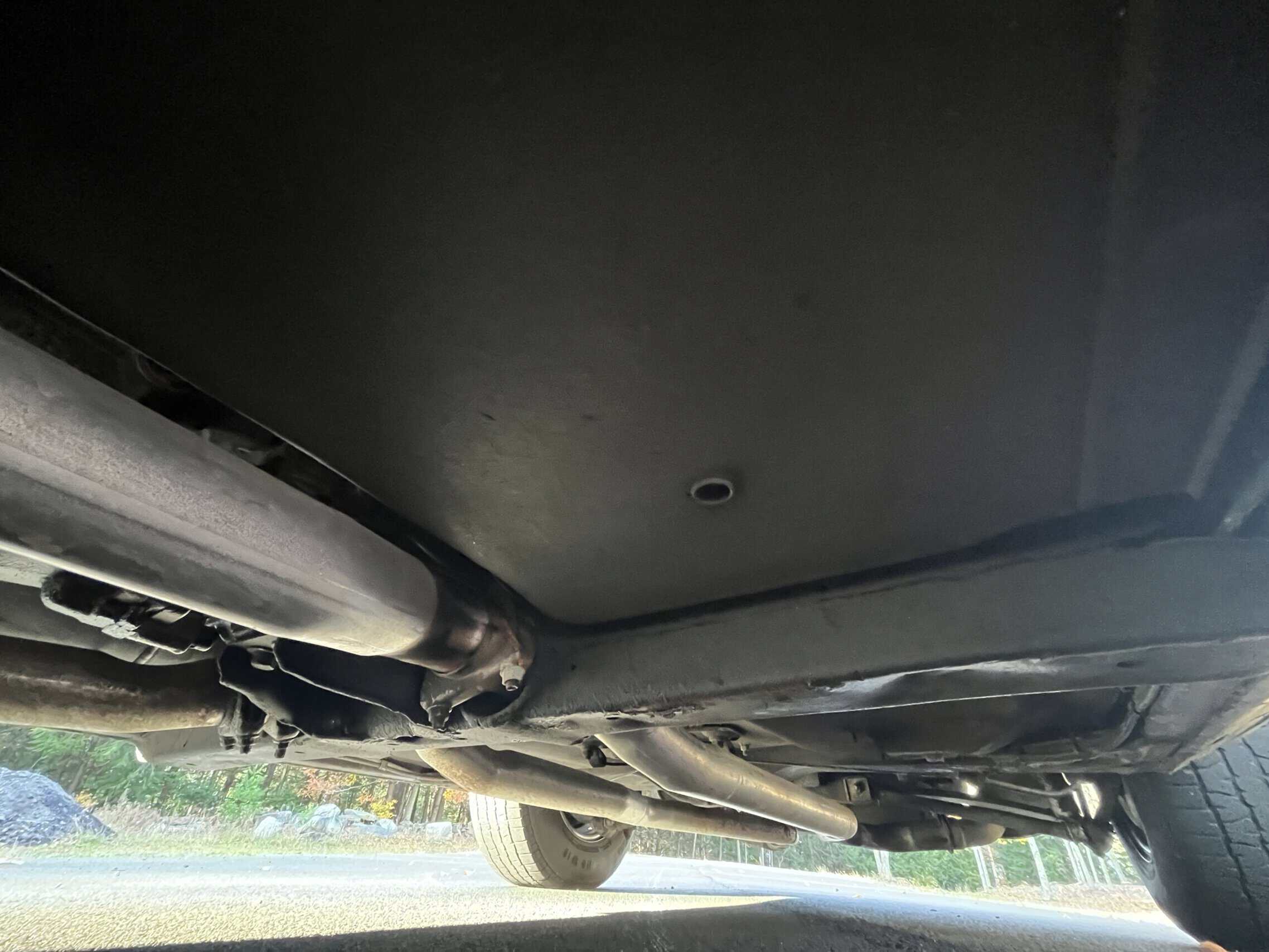 1972 Chevrolet corvette — Underneath view of a classic car showing exhaust system and chassis.