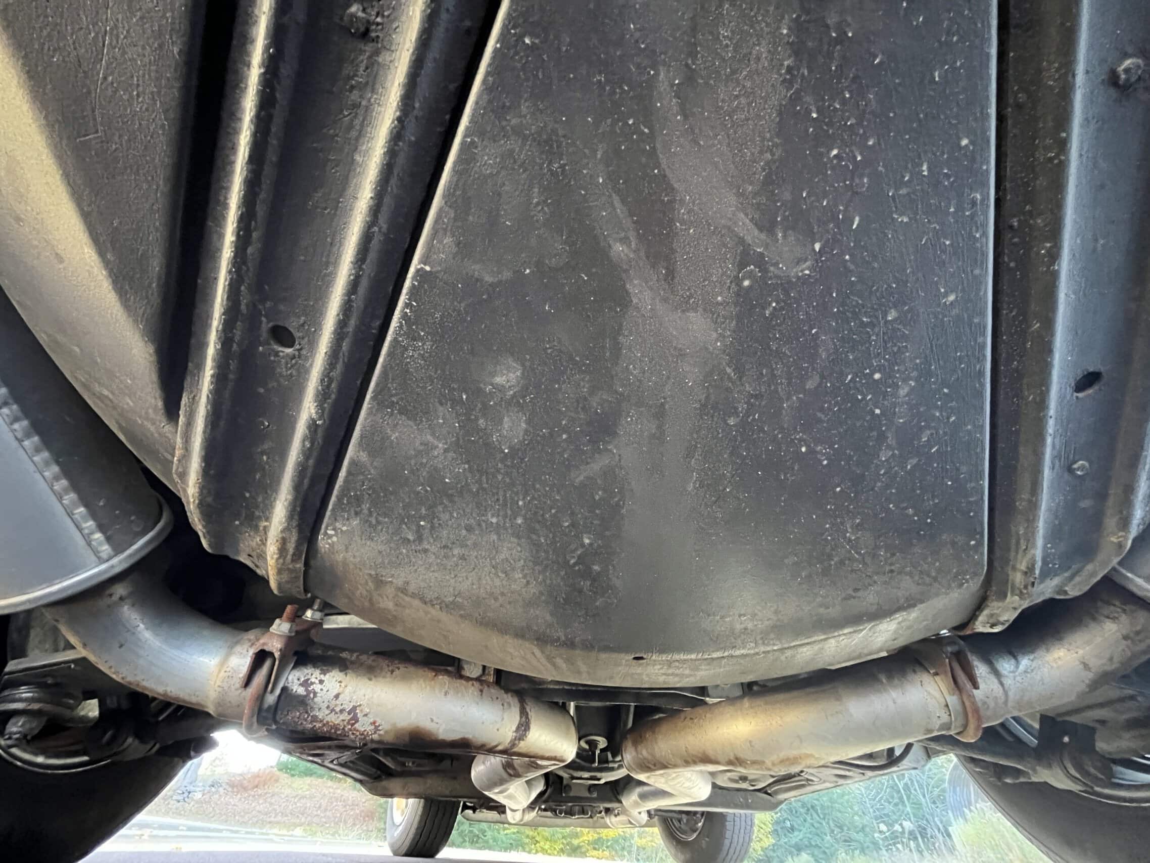 1972 Chevrolet corvette — Underneath view of a classic car showing exhaust pipes and chassis.