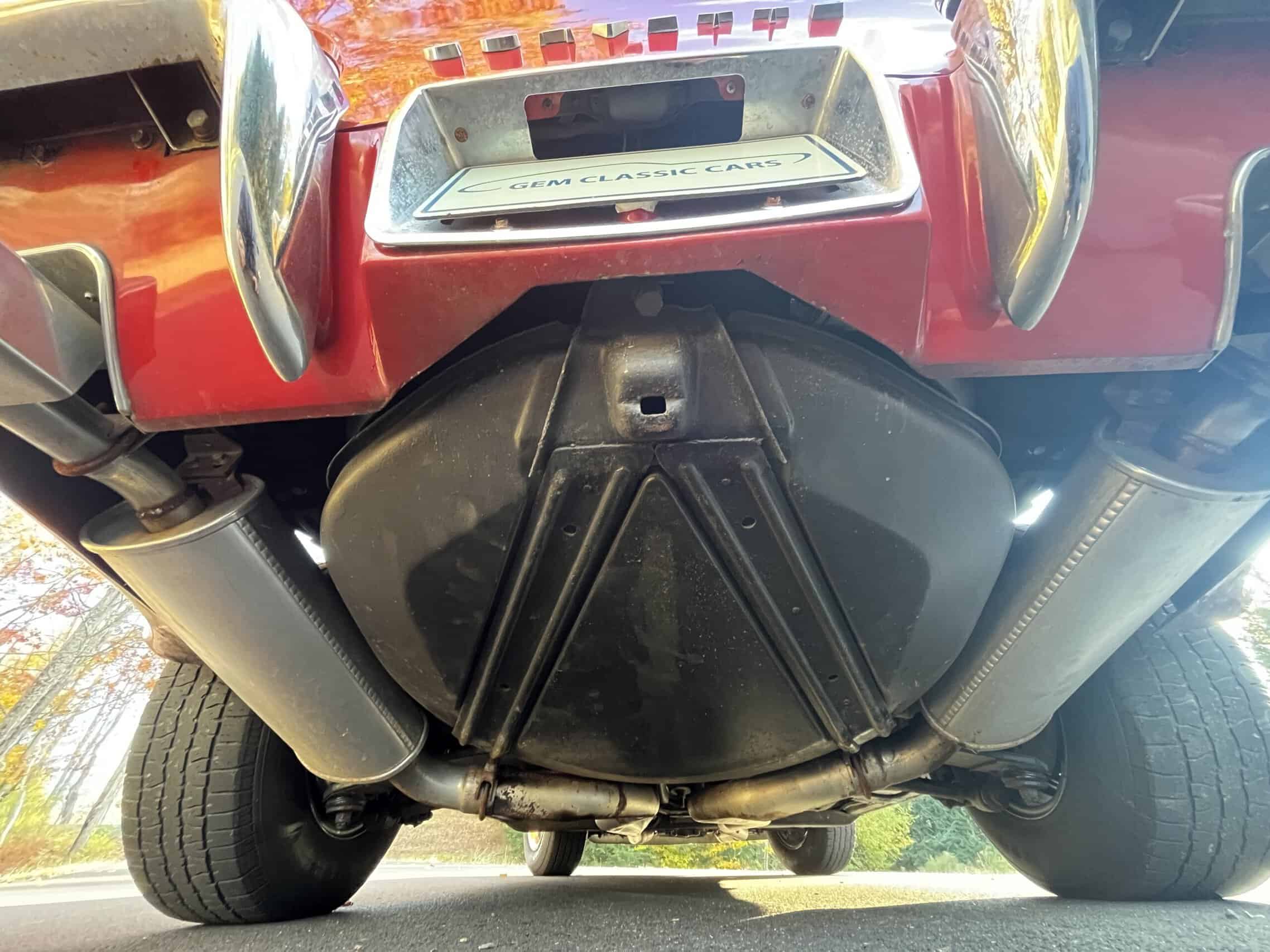 1972 Chevrolet corvette — Underneath view of a classic car engine and exhaust system.
