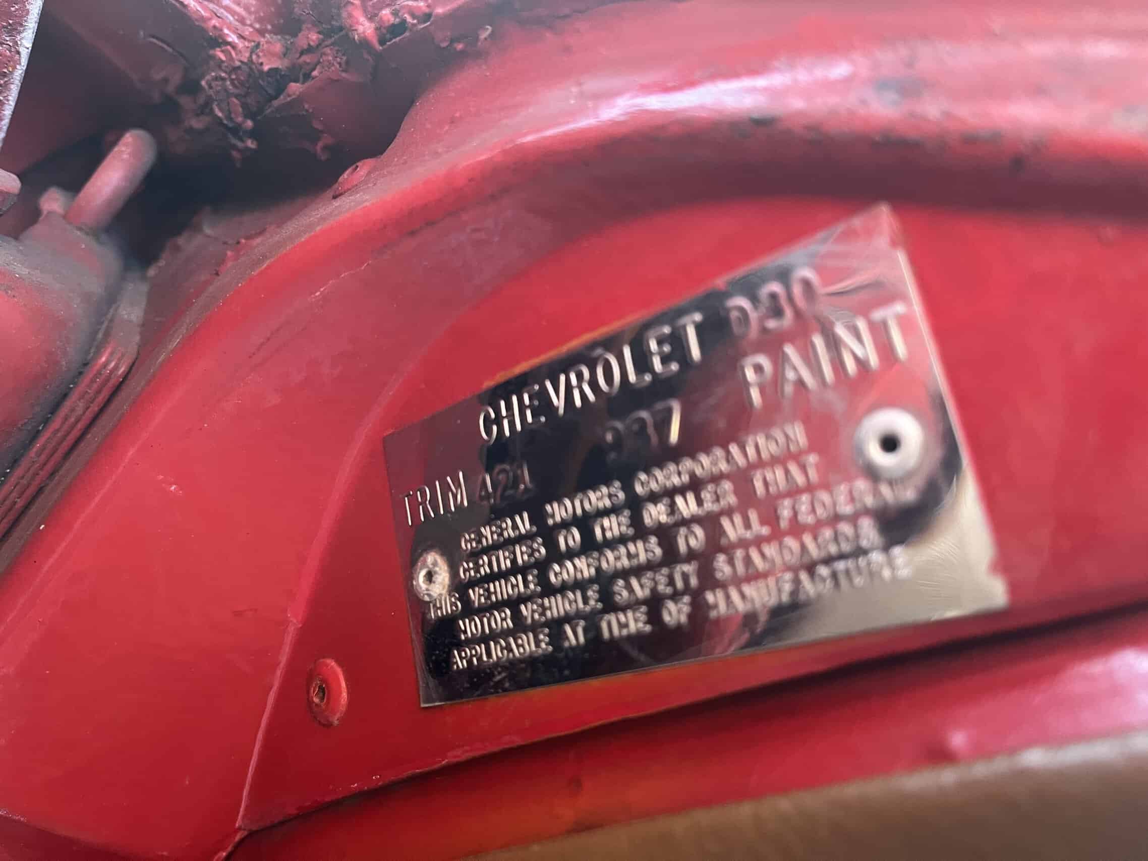 1972 Chevrolet corvette — Close-up of engine bay with Chevrolet metal plate and red paint.